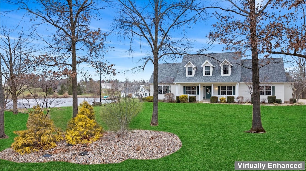 cape cod house with roof with shingles and a front lawn