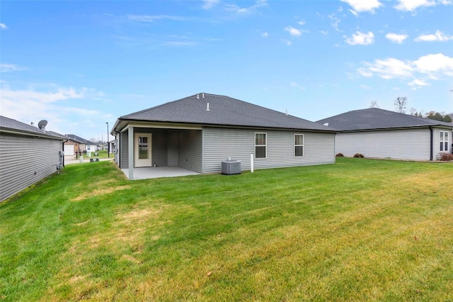 back of house with a patio area, central air condition unit, and a yard