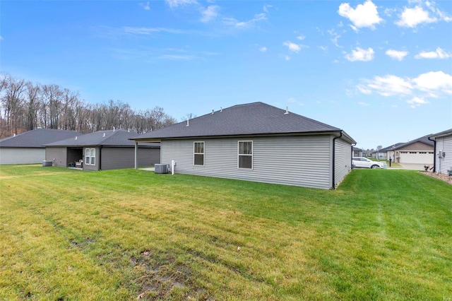 back of property featuring a yard and central AC unit