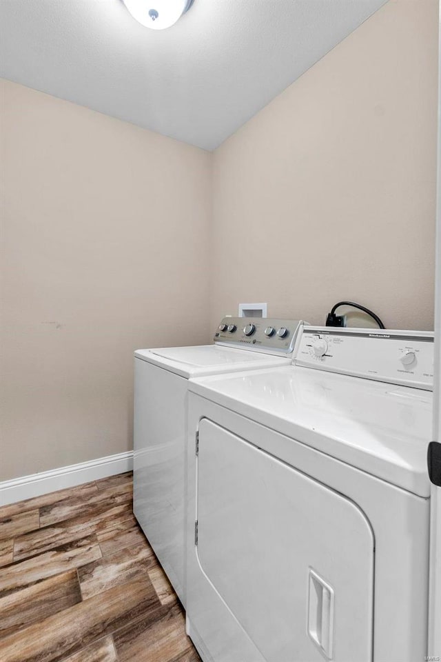 laundry room with light wood-type flooring and separate washer and dryer