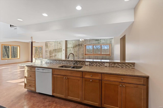 kitchen featuring white dishwasher, sink, tasteful backsplash, and light stone countertops