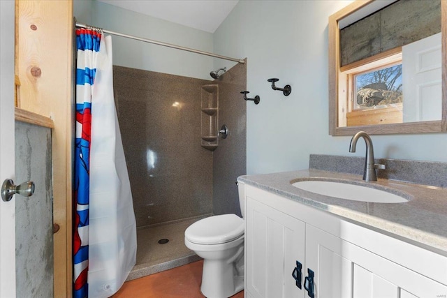 bathroom featuring a shower with curtain, vanity, and toilet