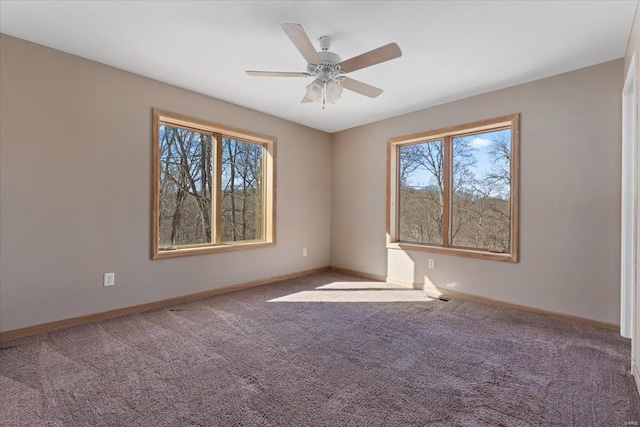 carpeted spare room featuring ceiling fan