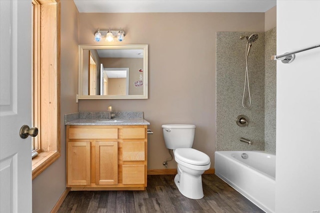 full bathroom with vanity, toilet, tiled shower / bath combo, and hardwood / wood-style floors