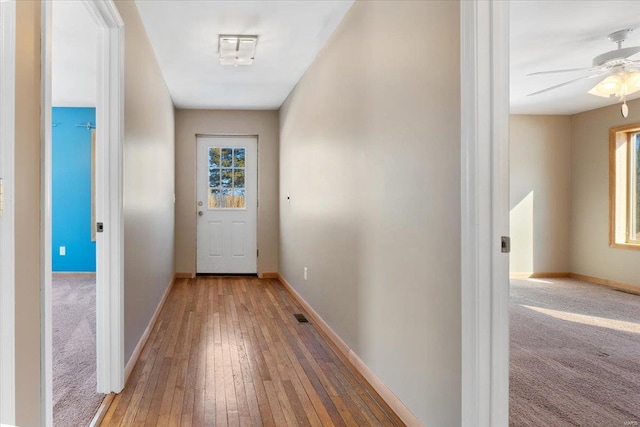 doorway to outside featuring a wealth of natural light, hardwood / wood-style floors, and ceiling fan