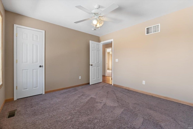 carpeted spare room with ceiling fan