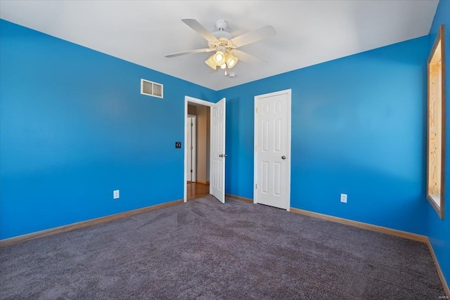 empty room with carpet and ceiling fan