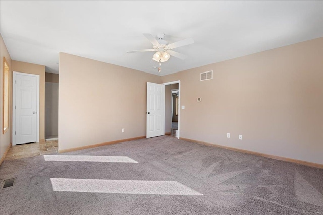 spare room featuring light carpet and ceiling fan