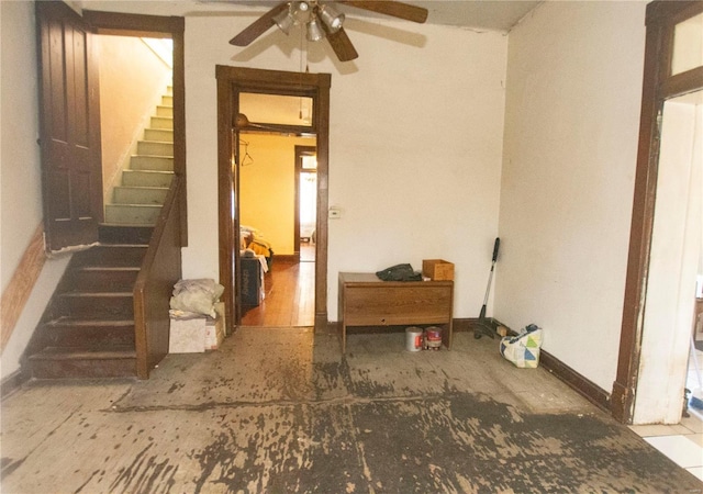 interior space with ceiling fan