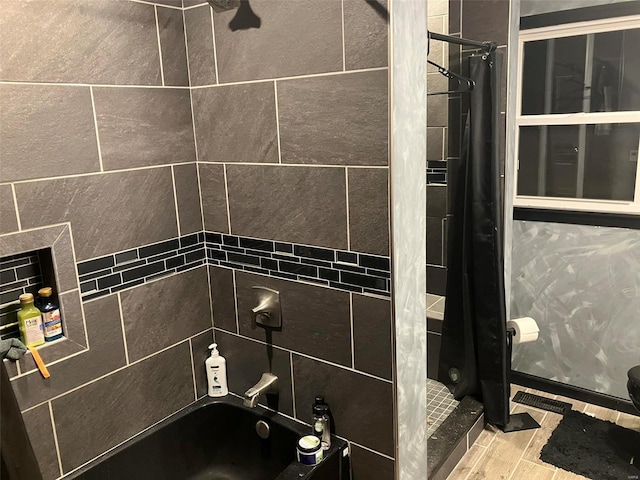 bathroom featuring shower / bath combination with curtain and tile walls