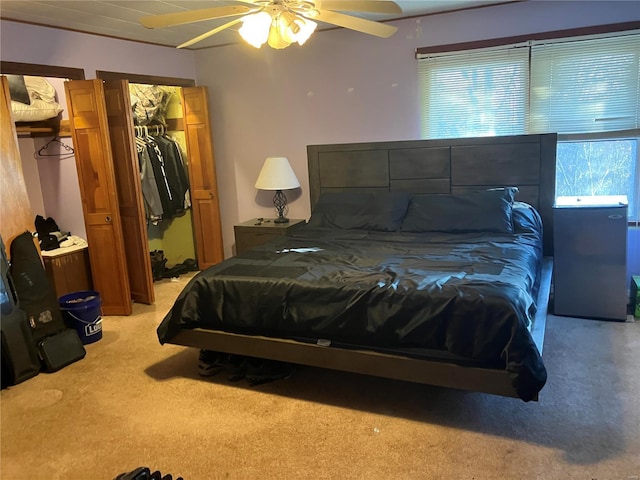 carpeted bedroom featuring ceiling fan, a closet, and a spacious closet