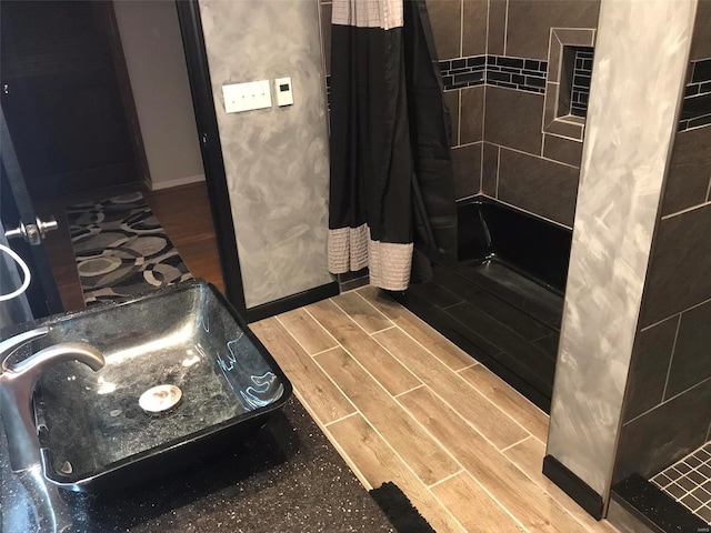 bathroom with sink and shower / bath combination with curtain