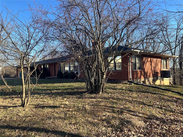 exterior space featuring a lawn and central air condition unit