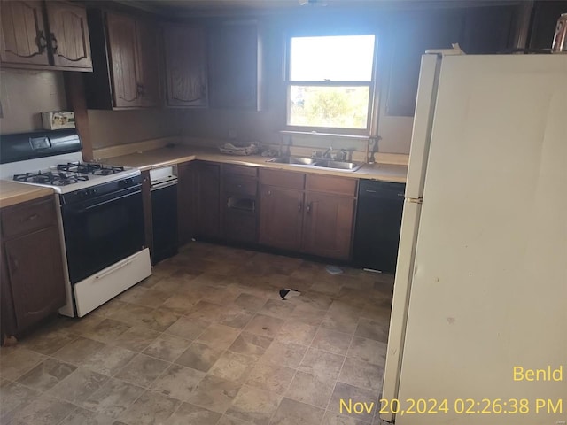 kitchen with dark brown cabinets, white appliances, and sink