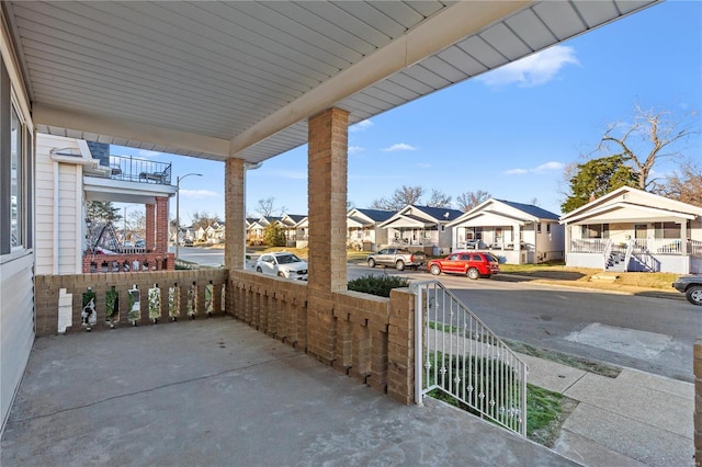 view of patio / terrace featuring a porch and a residential view