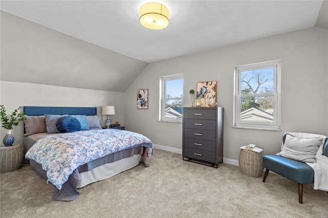 bedroom featuring lofted ceiling, baseboards, and light colored carpet