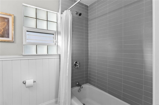 full bathroom featuring shower / tub combo and wainscoting