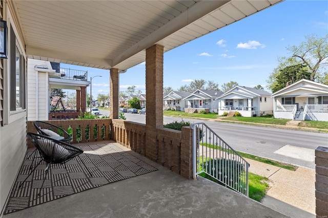 view of patio / terrace featuring a porch and a residential view