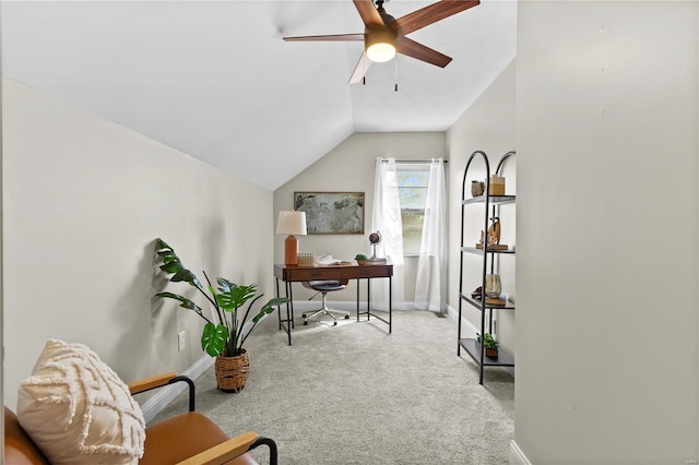 carpeted office space featuring lofted ceiling, a ceiling fan, and baseboards