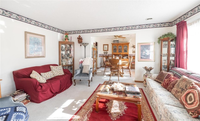 living room featuring carpet floors and ceiling fan