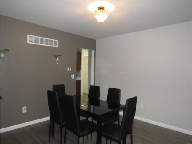 dining space with dark wood-type flooring