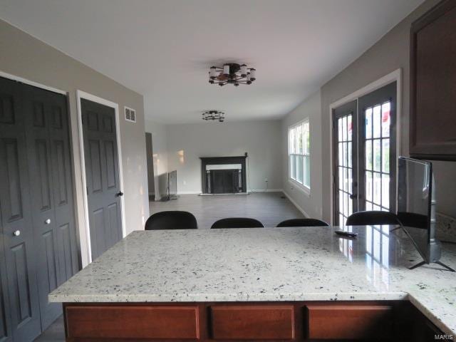 kitchen with light stone countertops and french doors