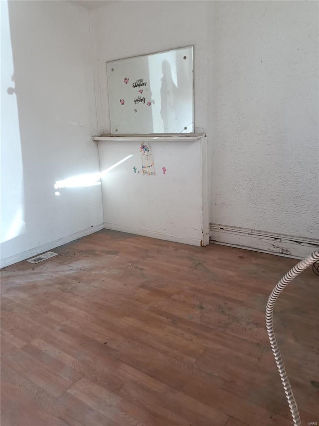 empty room featuring hardwood / wood-style flooring