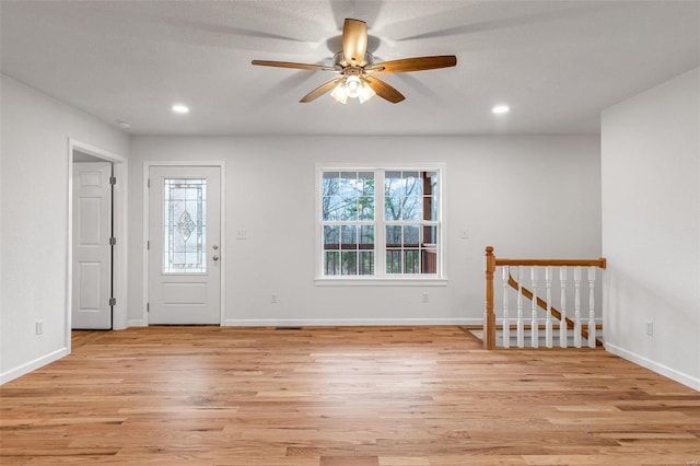 foyer with a textured ceiling, light hardwood / wood-style flooring, and ceiling fan