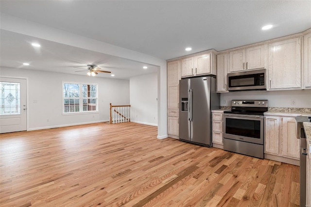 kitchen with ceiling fan, appliances with stainless steel finishes, and light hardwood / wood-style flooring