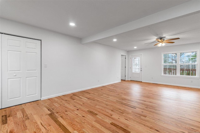 interior space with beamed ceiling, ceiling fan, and light wood-type flooring