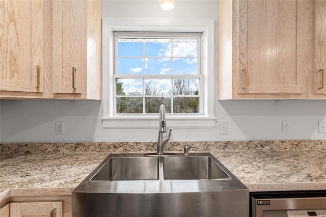 kitchen with light brown cabinetry, sink, and a healthy amount of sunlight