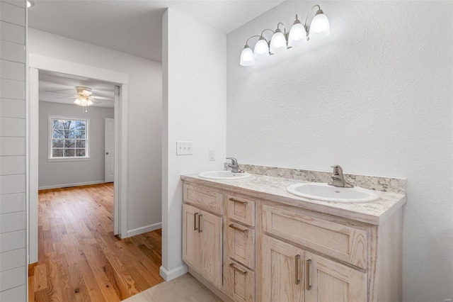 bathroom with vanity, ceiling fan, and wood-type flooring