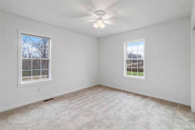 spare room with a healthy amount of sunlight and light colored carpet