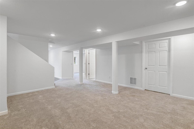 basement featuring light colored carpet