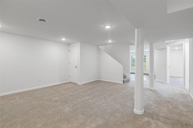 basement featuring light colored carpet