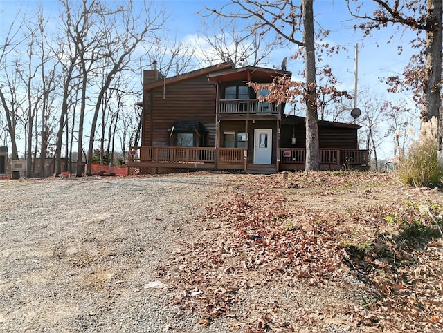 back of property featuring a balcony