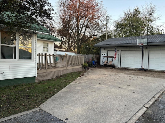 view of yard featuring an outbuilding, a deck, and a garage