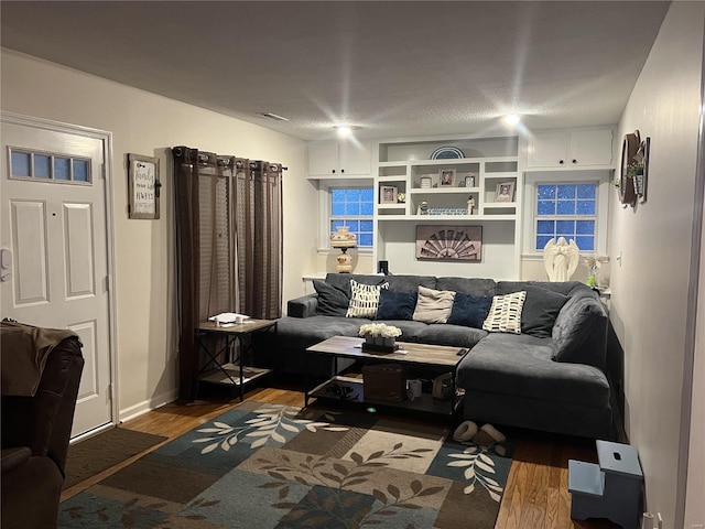 living room featuring a textured ceiling and hardwood / wood-style flooring