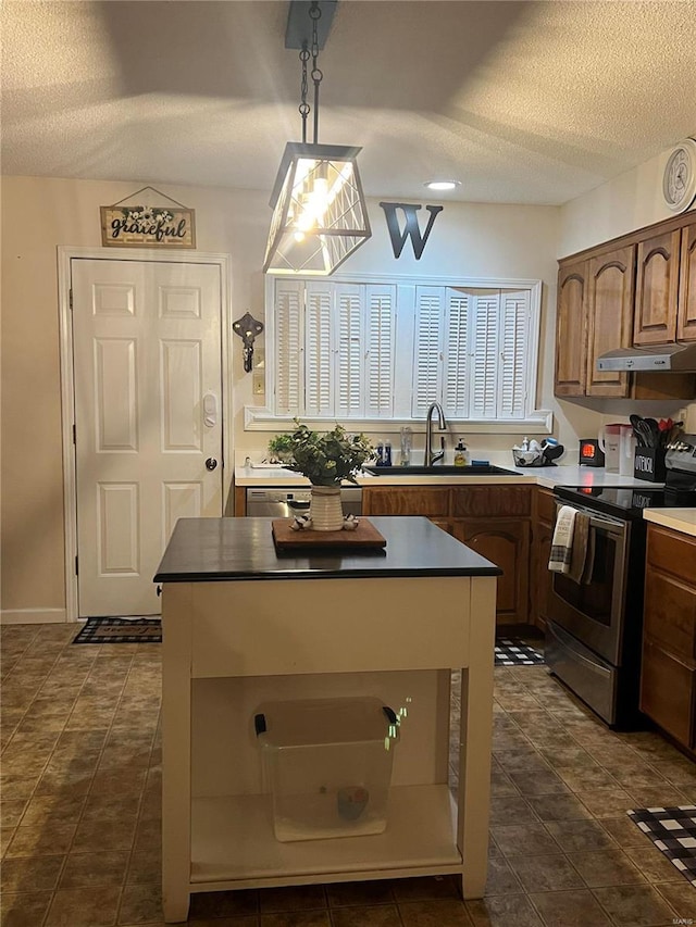 kitchen featuring a textured ceiling, electric range, decorative light fixtures, and exhaust hood