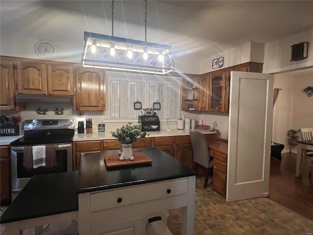 kitchen featuring pendant lighting, stainless steel electric range, and light hardwood / wood-style floors