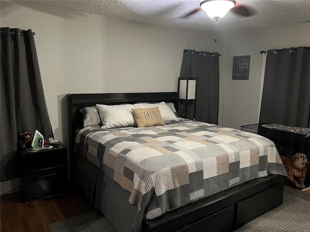 bedroom with wood-type flooring, a textured ceiling, and ceiling fan