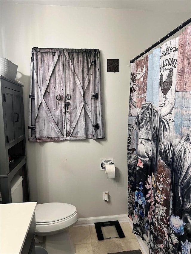 bathroom featuring tile patterned floors, vanity, and toilet