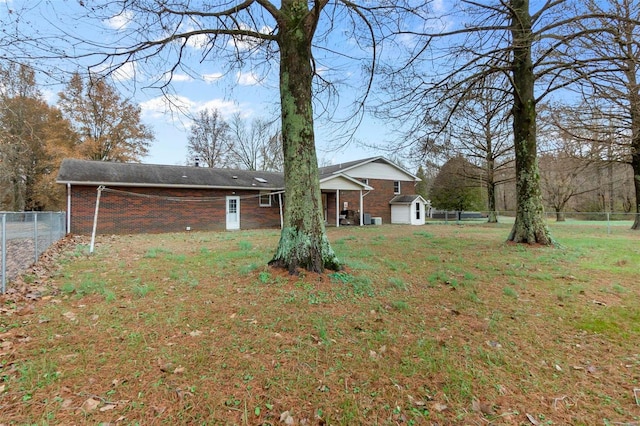 rear view of property with a lawn