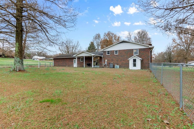 rear view of property featuring a yard