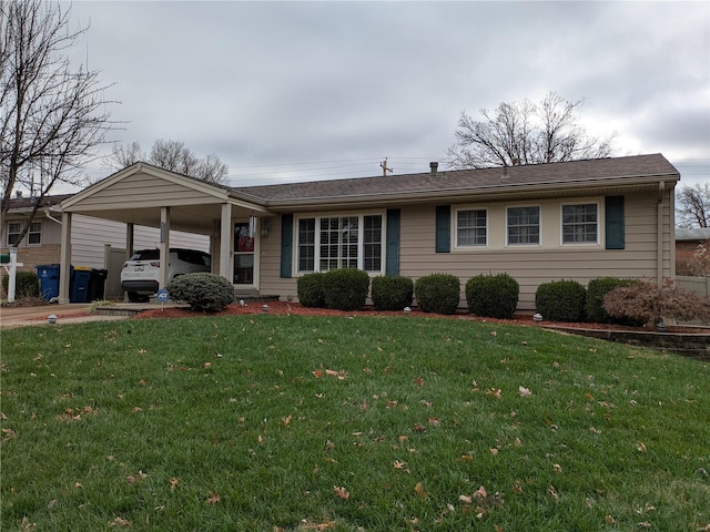 ranch-style home with a carport and a front yard