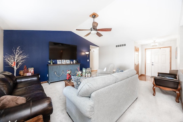 carpeted living room featuring ceiling fan and lofted ceiling