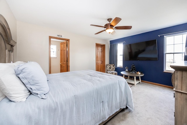 bedroom featuring ceiling fan and carpet