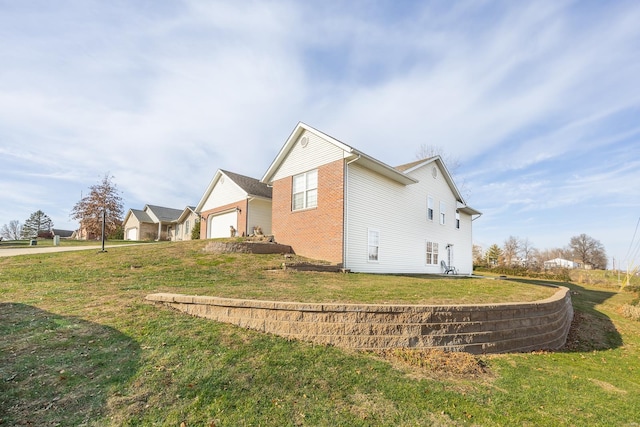 view of home's exterior featuring a lawn and a garage