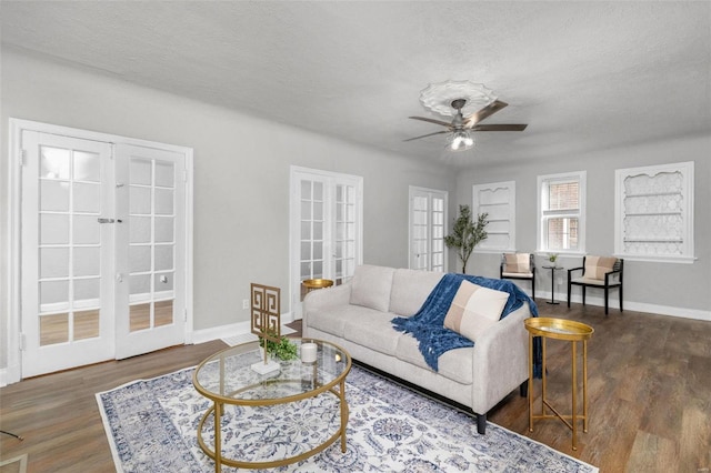 living room featuring french doors, a textured ceiling, and dark hardwood / wood-style floors