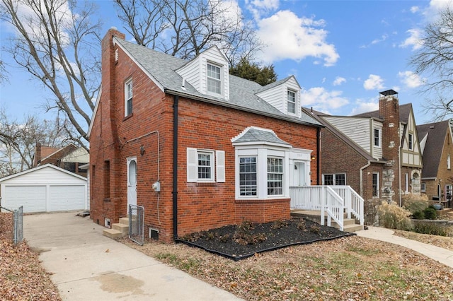 view of front of property with a garage and an outdoor structure